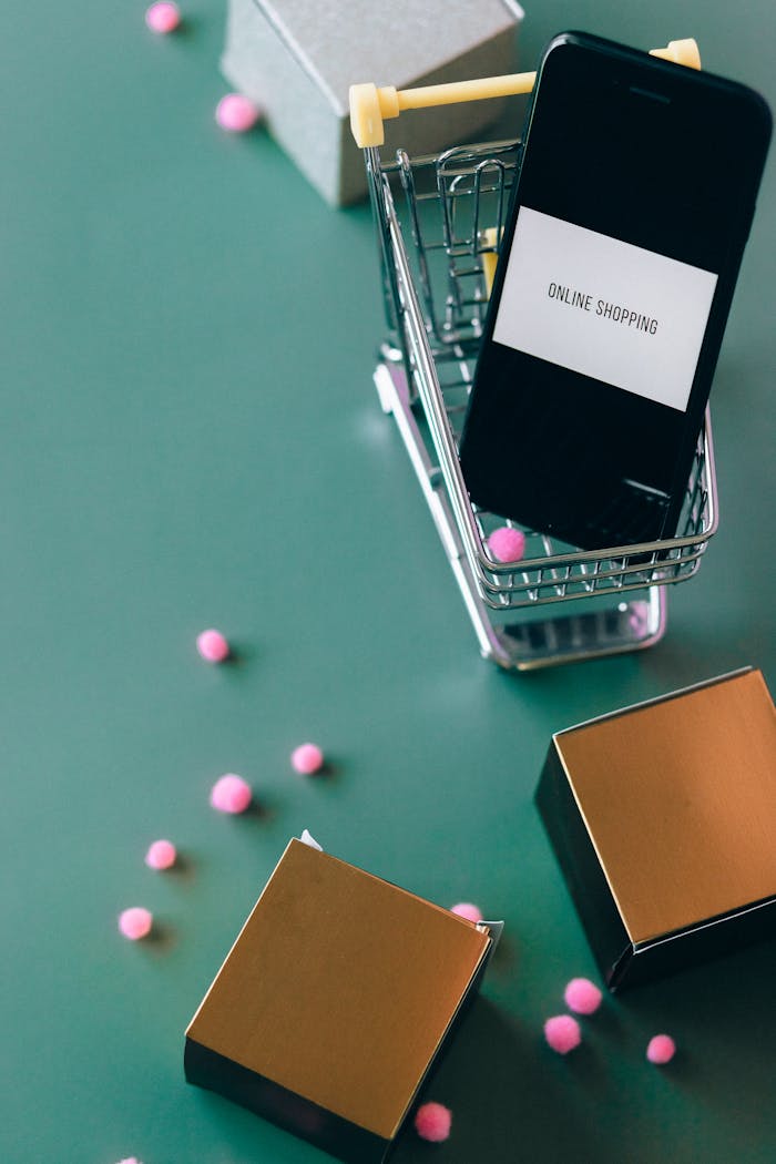 Mastering the First Impression: Your intriguing post title goes here Smartphone in miniature shopping cart illustrating online shopping and ecommerce concept.